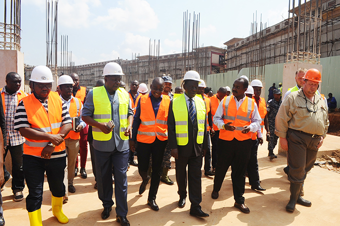 Sports Minister Bakabulindi (2L), Hamis Kiggundu, Vice President Ssekandi and Roko officials during the tour of the stadium.