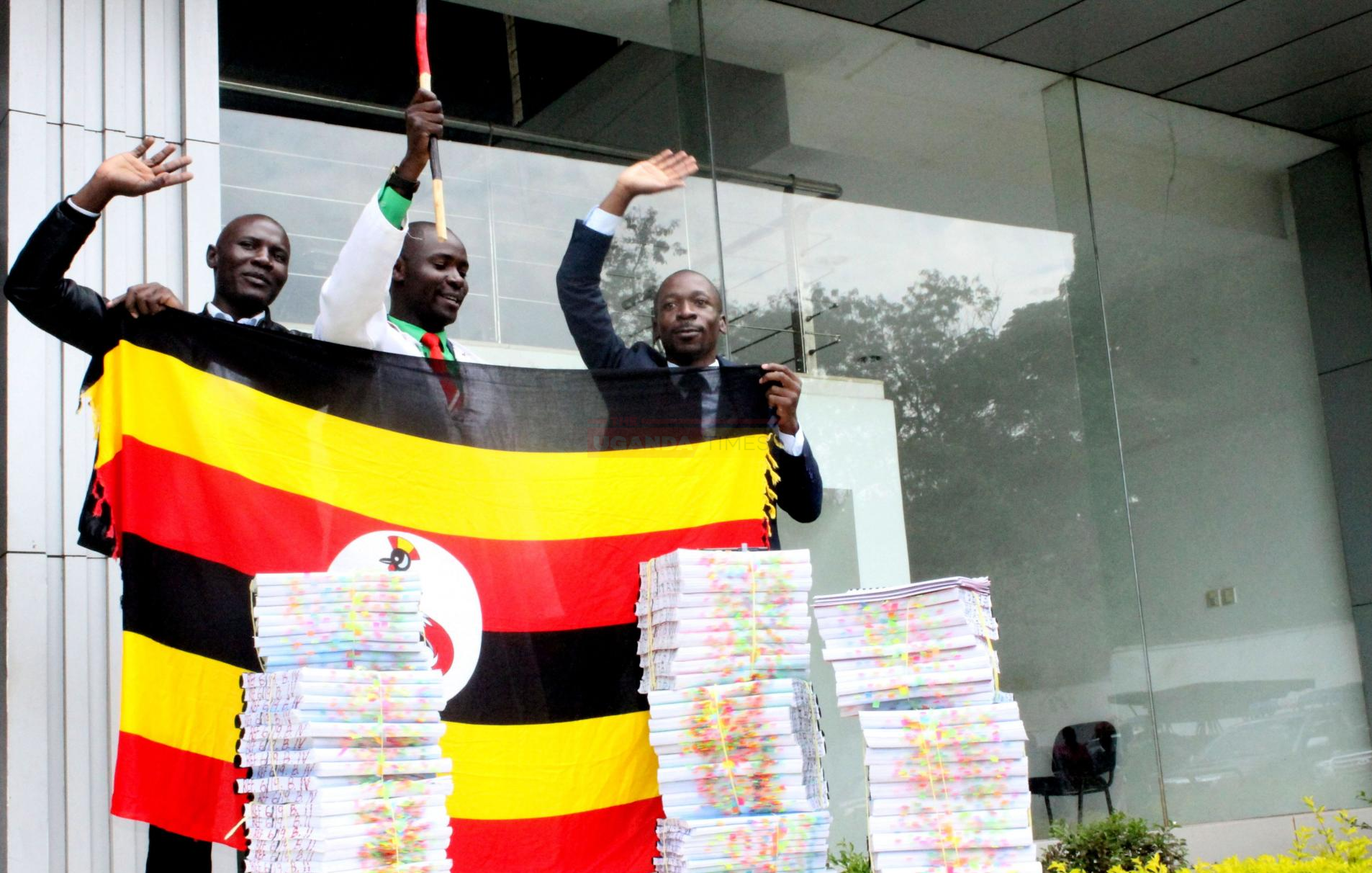 Activist Simon Wanyera and Isaac Ssemakadde accompany controversial lawyer Male Mabirizi as he files a list of surities to East African Court of Justice