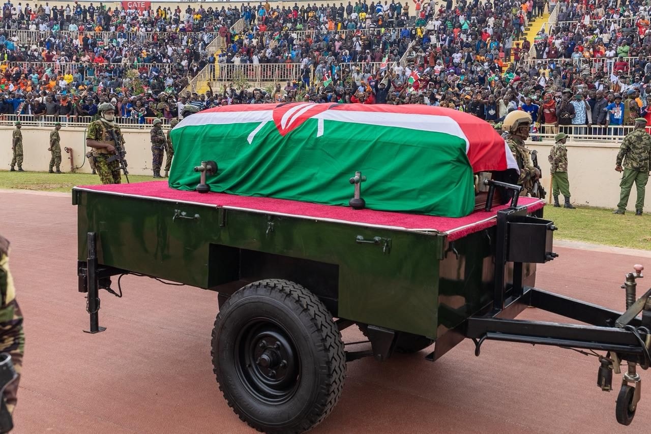 Raila Odinga Body Repatriated from India Kenya’s Prime Cabinet Secretary Musalia Mudavadi has led a government delegation to oversee the repatriation of Raila Odinga’s body from India, following the former Prime Minister’s death in Kerala on Wednesday. Odinga, 80, passed away after suffering a cardiac arrest while receiving Ayurvedic treatment at a wellness center. Mudavadi expressed Kenya’s appreciation to India for its swift cooperation during the difficult period. “India’s solidarity reflects the warm and long-standing friendship between our two nations,” he said in a statement shared by the State Department for Foreign and Diaspora Affairs. Arrival and Reception at JKIA According to Mudavadi, the aircraft carrying Raila Odinga’s body is expected to land at Jomo Kenyatta International Airport (JKIA) at 9:30 a.m. on Thursday, where it will be received by President William Ruto, the Odinga family, and senior government officials. “May his journey home unite us in reflection, respect, and shared love for our country,” Mudavadi wrote on his official X (formerly Twitter) account after confirming that all repatriation arrangements had been completed. The Kenyan government has declared a national mourning period and confirmed that Odinga will receive a state funeral with full military honours, underscoring his stature as one of Kenya’s most influential political figures. National Farewell and Burial Program The official burial program indicates that Raila Odinga’s body will lie in state at Parliament Buildings in Nairobi on Thursday afternoon for public viewing. A state funeral service will be held at Nyayo National Stadium on Friday, before the body is transported to Kisumu and later to Bondo, Siaya County, for burial on Sunday in line with Anglican Church traditions. President William Ruto described the late Odinga as “a titan of conscience, a visionary of uncommon resolve, and a defender of the defenceless whose legacy will illuminate Kenya’s democratic path for all time.” Leaders from across Africa are expected to attend the burial, marking a historic farewell to a man whose lifelong pursuit of democracy, justice, and national unity shaped modern Kenya.